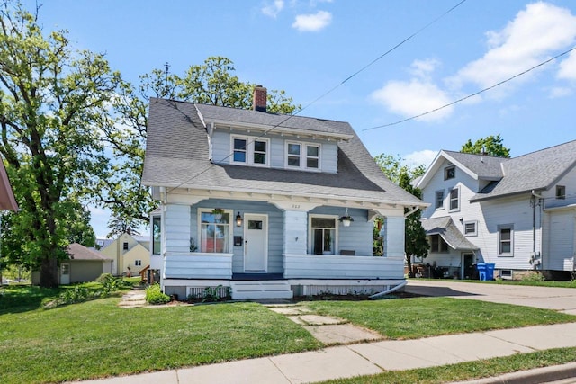 202 Lake St, Mount Horeb, WI 53572 - bungalow featuring a porch, a chimney, and a front yard