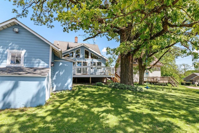 202 Lake St, Mount Horeb, WI 53572 - rear view of house featuring a deck, a yard, and a chimney
