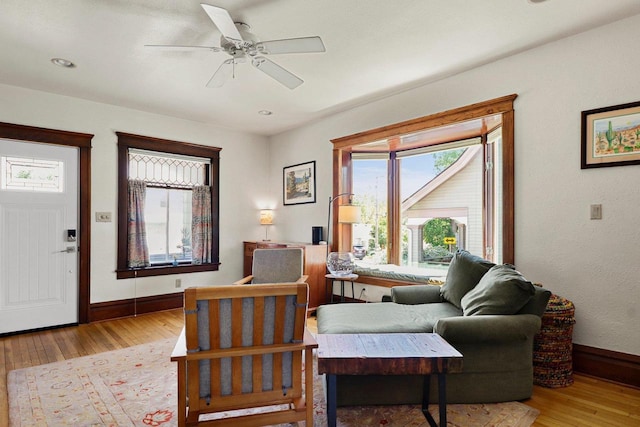 202 Lake St, Mount Horeb, WI 53572 - living area with wood finished floors, plenty of natural light, baseboards, and a ceiling fan
