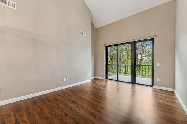 1512 Lake St, Baraboo, WI 53913 - spare room featuring high vaulted ceiling, dark wood-style floors, and baseboards