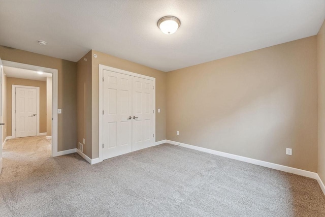 1512 Lake St, Baraboo, WI 53913 - unfurnished bedroom with carpet, a closet, and baseboards