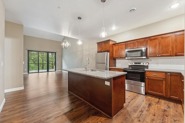 1512 Lake St, Baraboo, WI 53913 - kitchen with appliances with stainless steel finishes, a sink, brown cabinets, dark wood finished floors, and pendant lighting