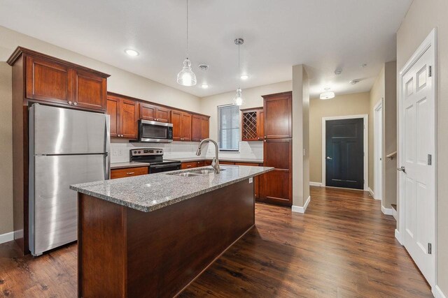1512 Lake St, Baraboo, WI 53913 - kitchen with appliances with stainless steel finishes, a sink, light stone counters, dark wood-style floors, and recessed lighting
