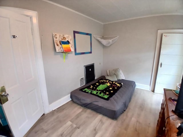 206 W Winnebago St, Appleton, WI 54911 - bedroom with wood finished floors, baseboards, and ornamental molding