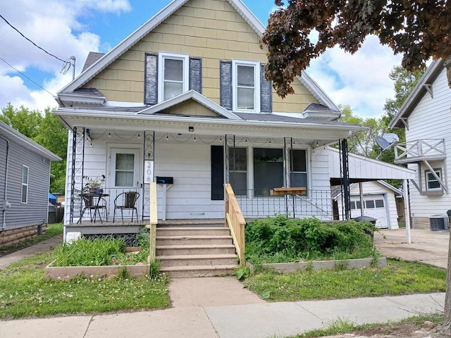 206 W Winnebago St, Appleton, WI 54911 - view of front of house with covered porch, cooling unit, an outbuilding, and a garage