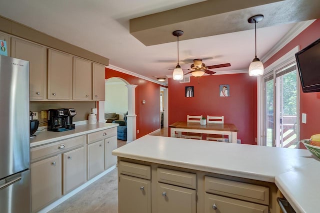 1621 W Crystal Dr, Edgerton, WI 53534 - kitchen featuring decorative columns, freestanding refrigerator, ceiling fan, arched walkways, and light countertops