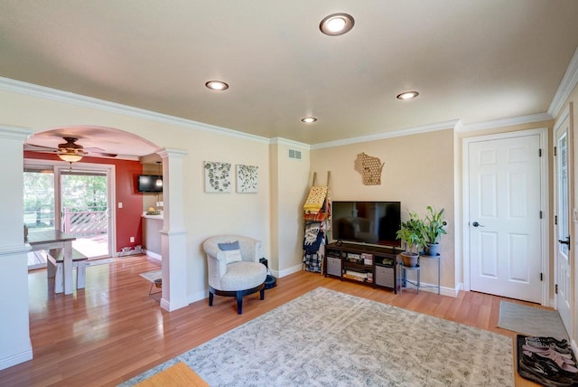 1621 W Crystal Dr, Edgerton, WI 53534 - living room with decorative columns, arched walkways, wood finished floors, ornamental molding, and recessed lighting