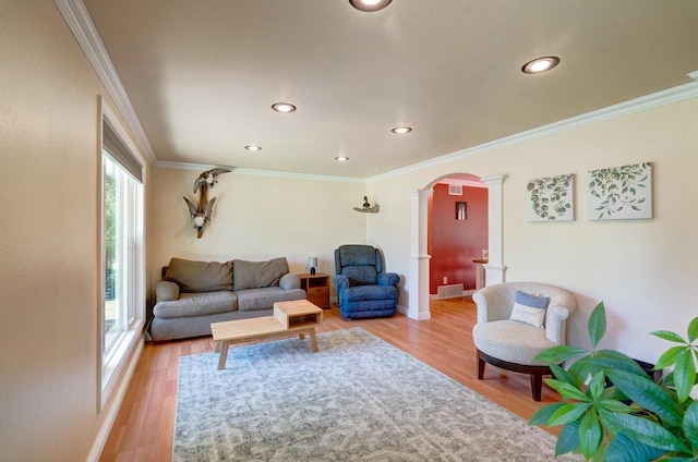 1621 W Crystal Dr, Edgerton, WI 53534 - living area featuring decorative columns, arched walkways, light wood-style flooring, recessed lighting, and ornamental molding