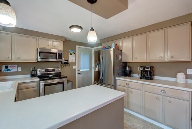 1621 W Crystal Dr, Edgerton, WI 53534 - kitchen with stainless steel appliances, light countertops, hanging light fixtures, and a peninsula