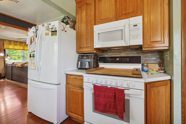 60 Madison Ave, Port Edwards, WI 54469 - kitchen featuring white appliances, backsplash, light countertops, dark wood-type flooring, and brown cabinetry