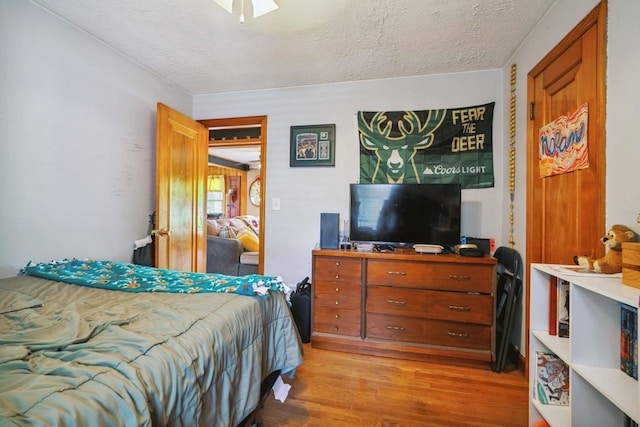 60 Madison Ave, Port Edwards, WI 54469 - bedroom with light wood-style flooring and a textured ceiling
