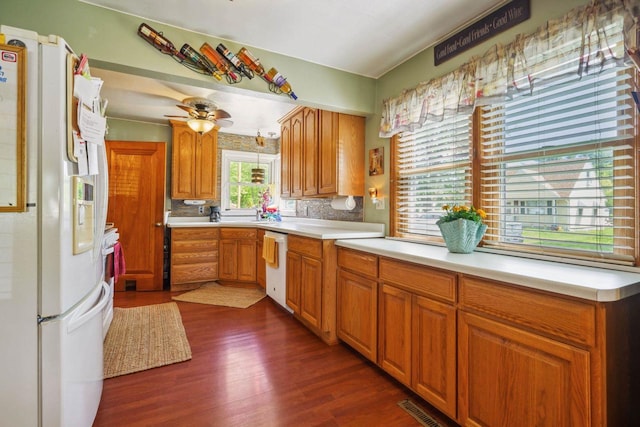 60 Madison Ave, Port Edwards, WI 54469 - kitchen with white appliances, dark wood-style floors, light countertops, brown cabinetry, and backsplash