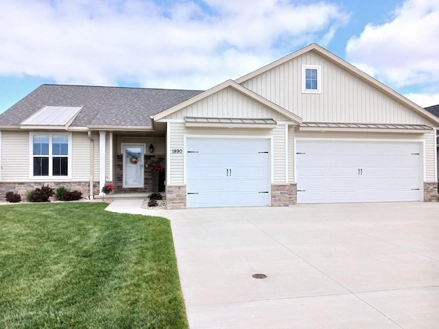 1890 Red Fox Ln, Kaukauna, WI 54130 - view of front facade with concrete driveway, stone siding, an attached garage, a standing seam roof, and board and batten siding