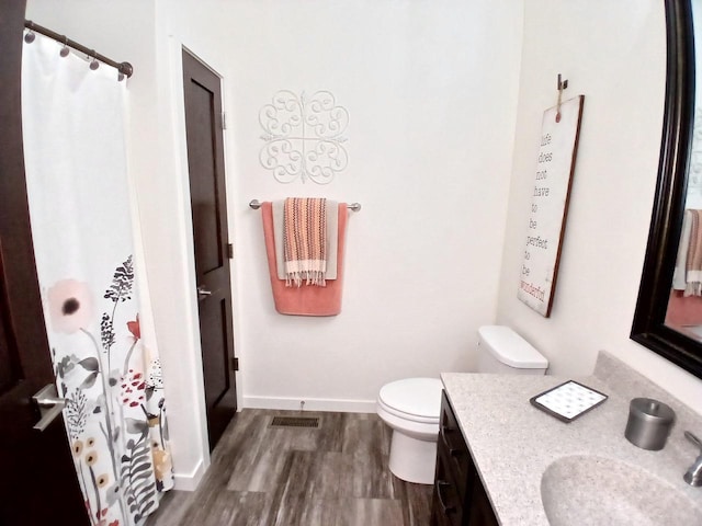 1890 Red Fox Ln, Kaukauna, WI 54130 - full bath with vanity, wood finished floors, toilet, baseboards, and a shower with shower curtain