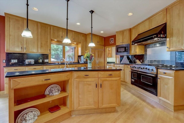 6625 Charles St, Racine, WI 53402 - kitchen with under cabinet range hood, double oven range, stainless steel microwave, dark countertops, and tasteful backsplash