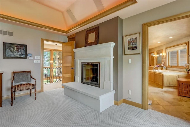 6625 Charles St, Racine, WI 53402 - living room with light carpet, baseboards, a glass covered fireplace, and a chandelier