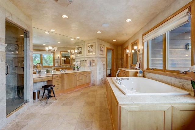 6625 Charles St, Racine, WI 53402 - full bath with recessed lighting, a whirlpool tub, vanity, a shower stall, and a chandelier