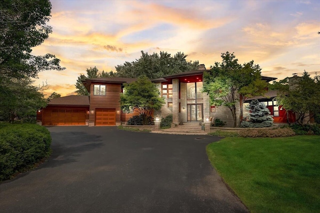 6625 Charles St, Racine, WI 53402 - contemporary home featuring driveway, a yard, and stone siding