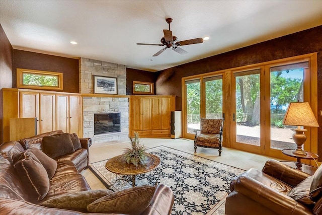 6625 Charles St, Racine, WI 53402 - living room with a stone fireplace, a ceiling fan, light carpet, and recessed lighting