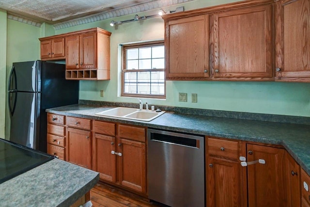 1235 Chandler St, Madison, WI 53715 - kitchen with stainless steel dishwasher, freestanding refrigerator, brown cabinets, and dark countertops