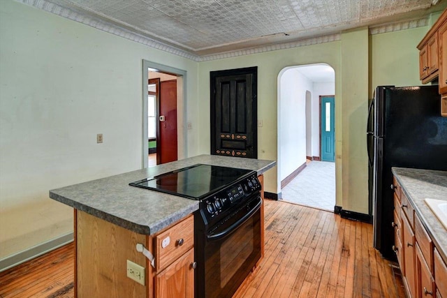 1235 Chandler St, Madison, WI 53715 - kitchen featuring black appliances, arched walkways, light wood-type flooring, baseboards, and an ornate ceiling
