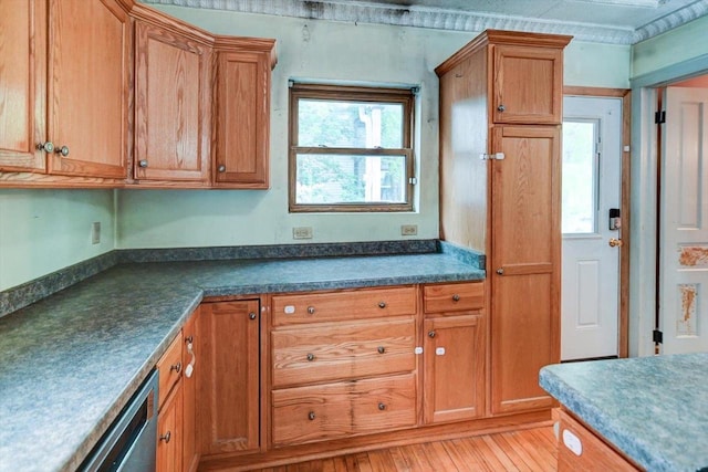 1235 Chandler St, Madison, WI 53715 - kitchen with brown cabinetry, dark countertops, and dishwasher
