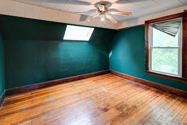 1235 Chandler St, Madison, WI 53715 - empty room with a skylight, hardwood / wood-style floors, baseboards, and ceiling fan