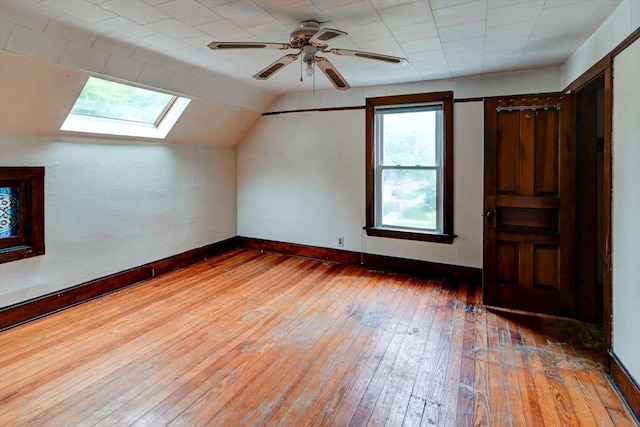 1235 Chandler St, Madison, WI 53715 - additional living space with a skylight, wood-type flooring, lofted ceiling, a ceiling fan, and baseboards
