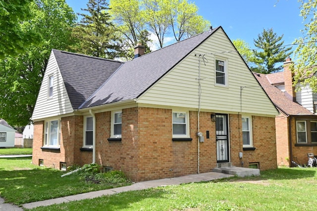 5002 N 24th Pl, Milwaukee, WI 53209 - view of front of property with brick siding, a front lawn, a shingled roof, and a chimney