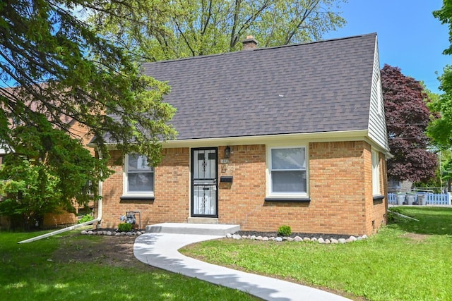 5002 N 24th Pl, Milwaukee, WI 53209 - view of front of property featuring a chimney, brick siding, a front lawn, and a shingled roof