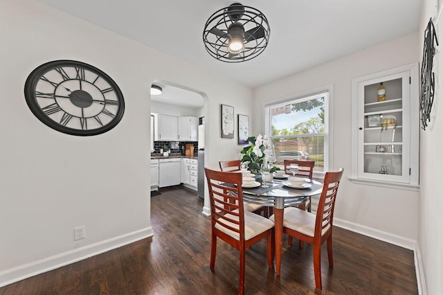 5002 N 24th Pl, Milwaukee, WI 53209 - dining area with baseboards, dark wood-style flooring, and arched walkways