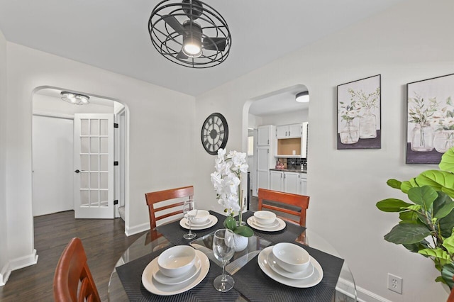 5002 N 24th Pl, Milwaukee, WI 53209 - dining area featuring arched walkways, baseboards, and dark wood-type flooring