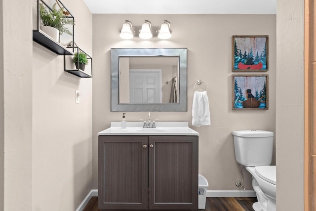 1254 Thorndale St, Green Bay, WI 54304 - bathroom with baseboards, wood finished floors, vanity, and toilet
