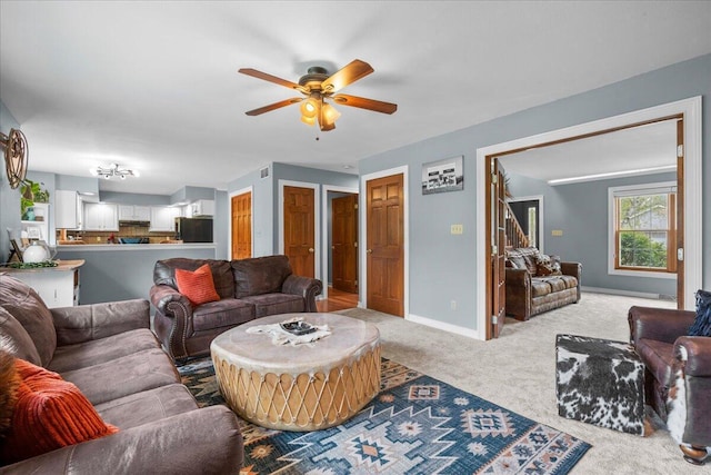 1620 Fieldstone Ln, Howards Grove, WI 53083 - living area with carpet, ceiling fan, and baseboards