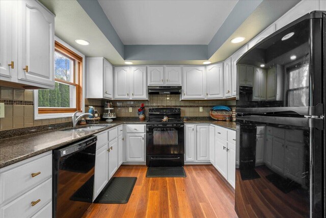 1620 Fieldstone Ln, Howards Grove, WI 53083 - kitchen featuring black appliances, under cabinet range hood, dark countertops, and recessed lighting