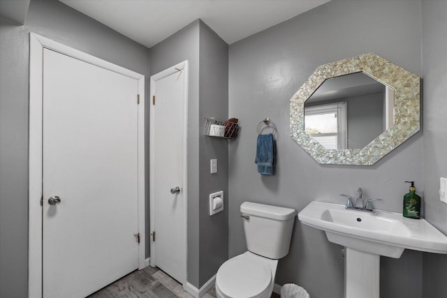 4683 N 80th St, Milwaukee, WI 53218 - half bath featuring toilet, wood finished floors, and baseboards