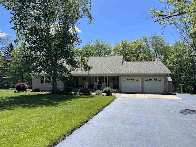 S9085 Meadowdale Rd, Prairie Du Sac, WI 53578 - ranch-style house with an attached garage, driveway, covered porch, a front yard, and roof with shingles