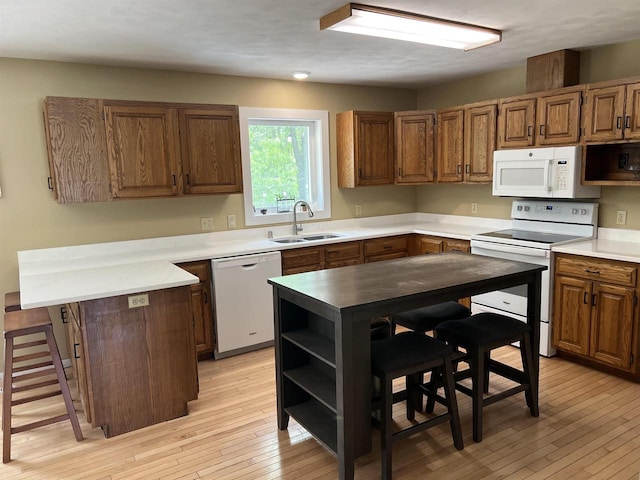 S9085 Meadowdale Rd, Prairie Du Sac, WI 53578 - kitchen featuring white appliances, a sink, open shelves, and light wood-style flooring