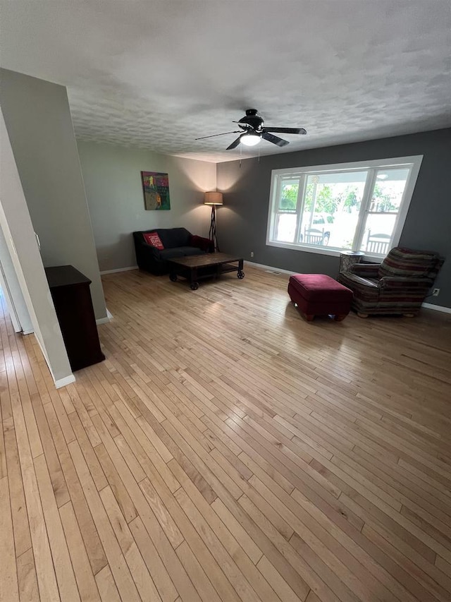 S9085 Meadowdale Rd, Prairie Du Sac, WI 53578 - living area featuring baseboards, a ceiling fan, and light wood-style flooring
