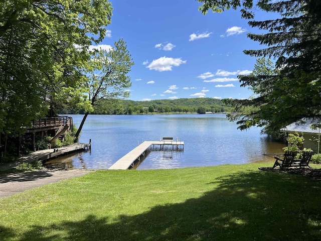 S9085 Meadowdale Rd, Prairie Du Sac, WI 53578 - dock featuring a water view, a wooded view, and a lawn
