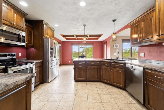 4201 Fieldcrest Dr, Kaukauna, WI 54130 - kitchen with appliances with stainless steel finishes, a sink, a peninsula, recessed lighting, and decorative light fixtures