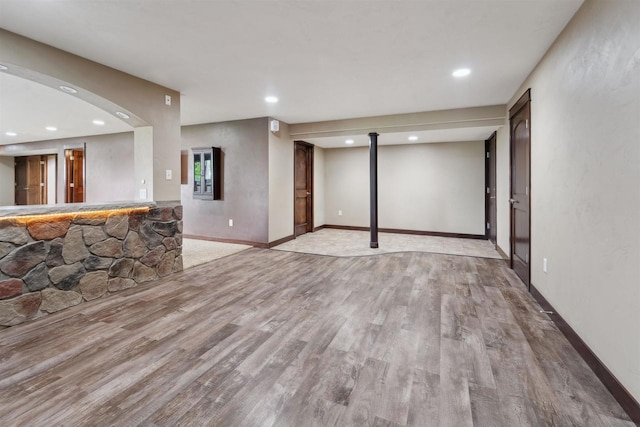 4201 Fieldcrest Dr, Kaukauna, WI 54130 - unfurnished living room featuring wood finished floors, recessed lighting, baseboards, and bar area
