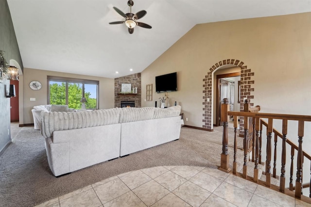 4201 Fieldcrest Dr, Kaukauna, WI 54130 - living area with vaulted ceiling, light colored carpet, a ceiling fan, a large fireplace, and arched walkways