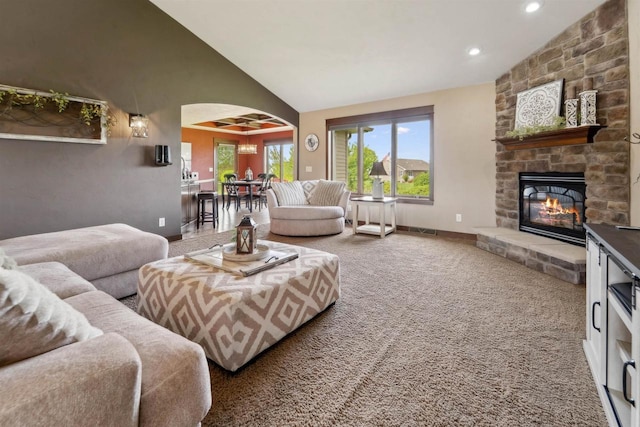 4201 Fieldcrest Dr, Kaukauna, WI 54130 - living room with arched walkways, carpet floors, a stone fireplace, baseboards, and recessed lighting