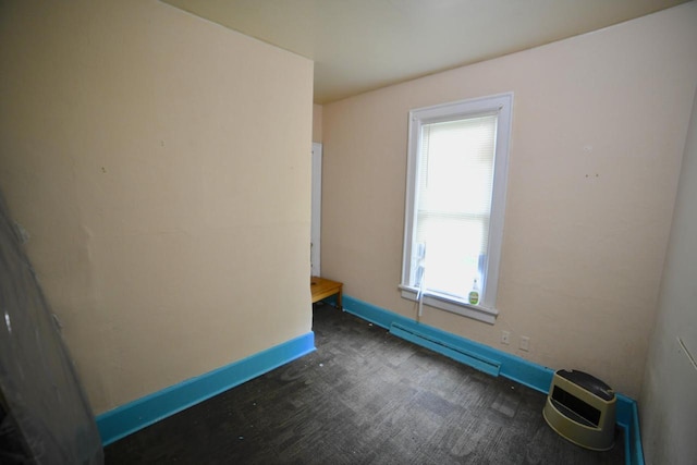 1925 W Center St, Milwaukee, WI 53206 - empty room featuring a baseboard radiator, baseboards, and dark carpet