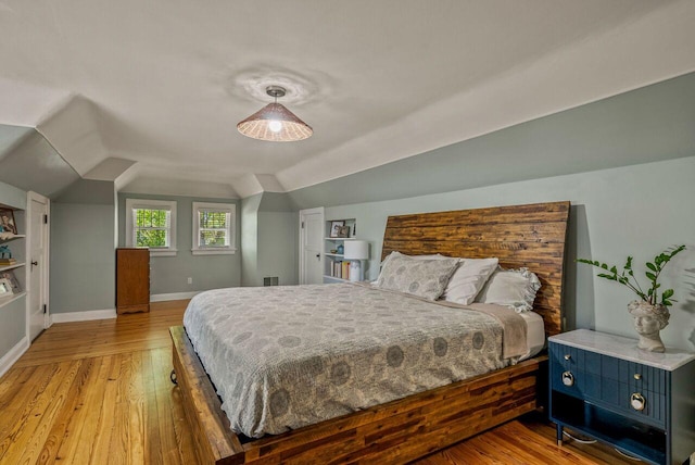 5642 N Argyle Ave, Glendale, WI 53209 - bedroom with vaulted ceiling, light wood-style floors, and baseboards