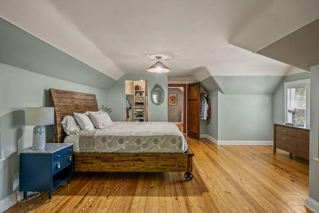 5642 N Argyle Ave, Glendale, WI 53209 - bedroom with vaulted ceiling, light wood finished floors, baseboards, and a spacious closet