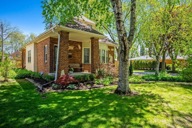 5642 N Argyle Ave, Glendale, WI 53209 - view of front facade with a chimney, brick siding, and a front lawn