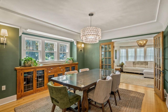 5642 N Argyle Ave, Glendale, WI 53209 - dining space featuring a chandelier, plenty of natural light, and light wood-style flooring
