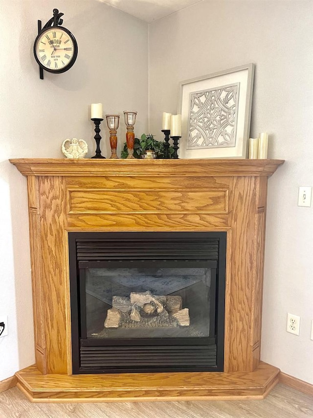 1401 E Bedford Ln, Appleton, WI 54915 - detailed view of a glass covered fireplace, wood finished floors, and baseboards